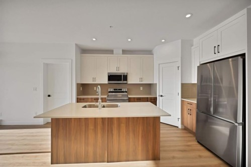 7322-1802 Mahagony Boulevard Se, Calgary, AB - Indoor Photo Showing Kitchen With Double Sink