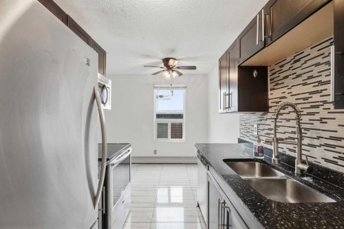 204-2611 15A Street Sw, Calgary, AB - Indoor Photo Showing Kitchen With Double Sink