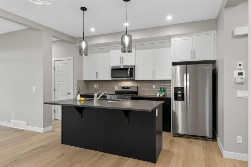 37 Southborough Lane, Cochrane, AB - Indoor Photo Showing Kitchen With Double Sink With Upgraded Kitchen