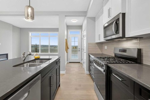 37 Southborough Lane, Cochrane, AB - Indoor Photo Showing Kitchen With Double Sink With Upgraded Kitchen