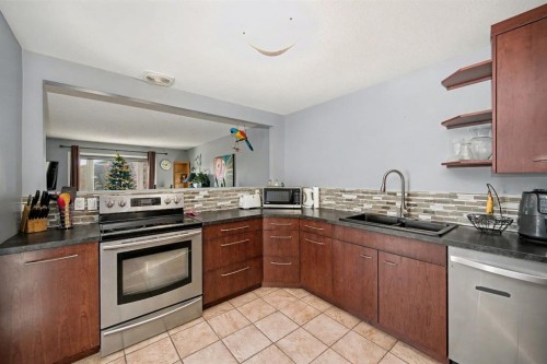 106 Eldorado Road Se, Airdrie, AB - Indoor Photo Showing Kitchen With Double Sink