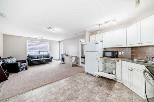 411-2000 Applevillage Court Se, Calgary, AB - Indoor Photo Showing Kitchen With Double Sink
