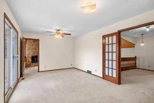 40 Edforth Road Nw, Calgary, AB - Indoor Photo Showing Other Room With Fireplace
