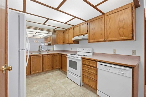 12 Arbour Cliff Close Nw, Calgary, AB - Indoor Photo Showing Kitchen With Double Sink
