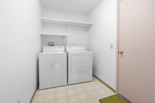 12 Arbour Cliff Close Nw, Calgary, AB - Indoor Photo Showing Laundry Room