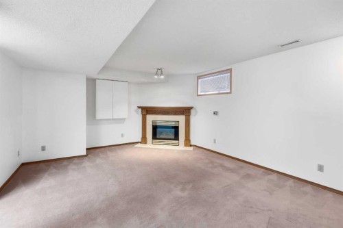 12 Arbour Cliff Close Nw, Calgary, AB - Indoor Photo Showing Other Room With Fireplace