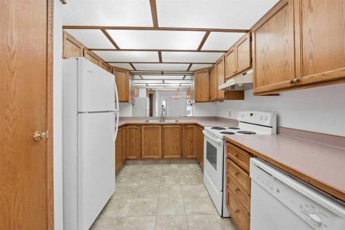 12 Arbour Cliff Close Nw, Calgary, AB - Indoor Photo Showing Kitchen With Double Sink