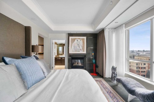 804-690 Princeton Way Sw, Calgary, AB - Indoor Photo Showing Bedroom With Fireplace