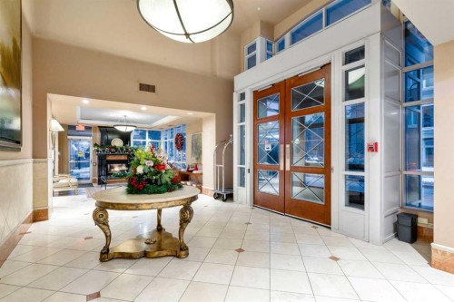 804-690 Princeton Way Sw, Calgary, AB - Indoor Photo Showing Other Room With Fireplace