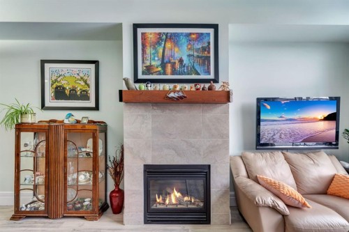 304-518 33 Street Nw, Calgary, AB - Indoor Photo Showing Living Room With Fireplace