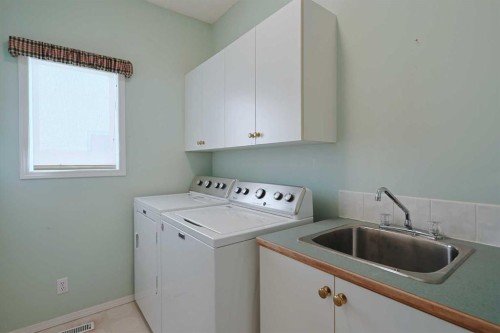108 Hamptons Heights Nw, Calgary, AB - Indoor Photo Showing Laundry Room