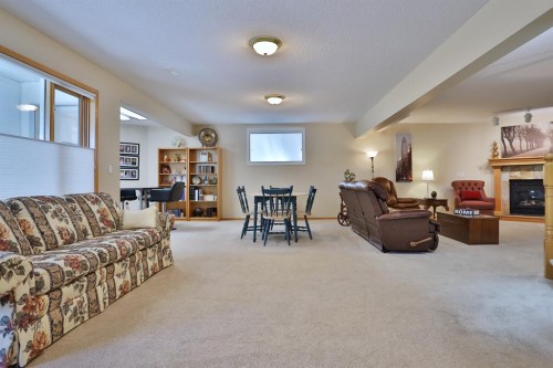 185 Hamptons Square Nw, Calgary, AB - Indoor Photo Showing Other Room With Fireplace