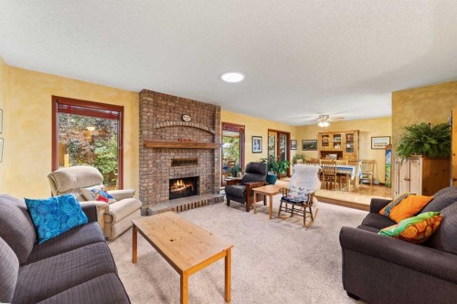25 Westheights Drive, Didsbury, AB - Indoor Photo Showing Living Room With Fireplace