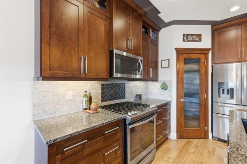 166 Fireside Bend, Cochrane, AB - Indoor Photo Showing Kitchen With Upgraded Kitchen