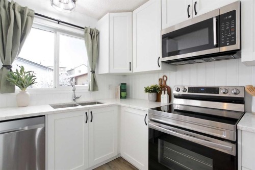 2348 Reunion Rise Nw, Airdrie, AB - Indoor Photo Showing Kitchen With Double Sink