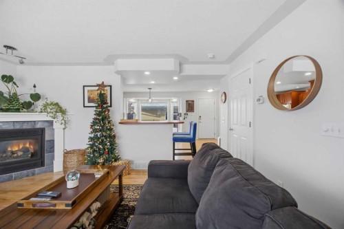 172 Somme Manor Sw, Calgary, AB - Indoor Photo Showing Living Room With Fireplace