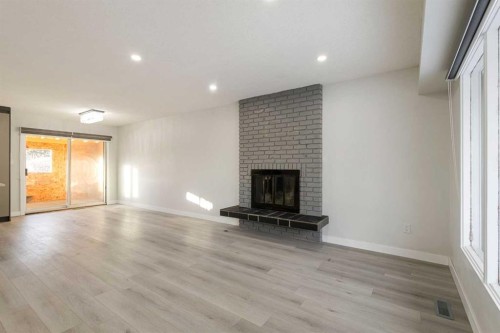 255 Rundleridge Drive Ne, Calgary, AB - Indoor Photo Showing Other Room With Fireplace