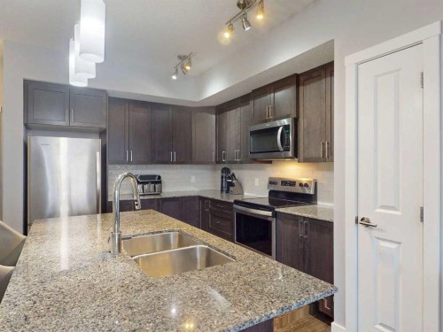 2207-3727 Sage Hill Drive Nw, Calgary, AB - Indoor Photo Showing Kitchen With Double Sink With Upgraded Kitchen