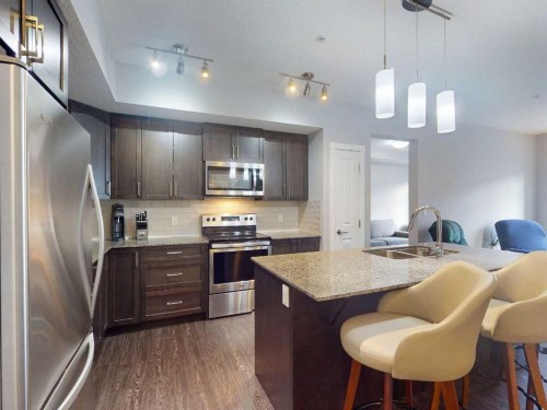 2207-3727 Sage Hill Drive Nw, Calgary, AB - Indoor Photo Showing Kitchen With Double Sink With Upgraded Kitchen