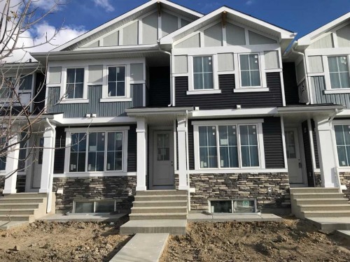 338 Sundown Road, Cochrane, AB - Outdoor With Facade