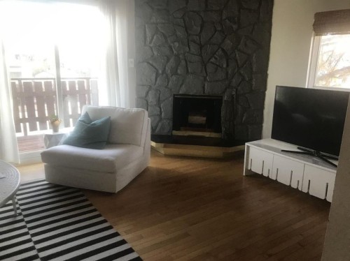 2135 Spiller Road Se, Calgary, AB - Indoor Photo Showing Living Room With Fireplace