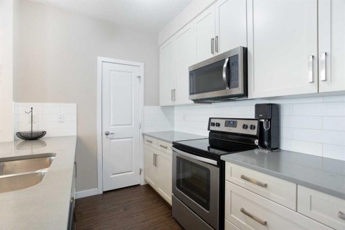 112-200 Cranfield Common Se, Calgary, AB - Indoor Photo Showing Kitchen With Double Sink With Upgraded Kitchen