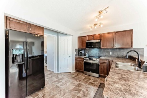 1809 Baywater Gardens Sw, Airdrie, AB - Indoor Photo Showing Kitchen With Double Sink