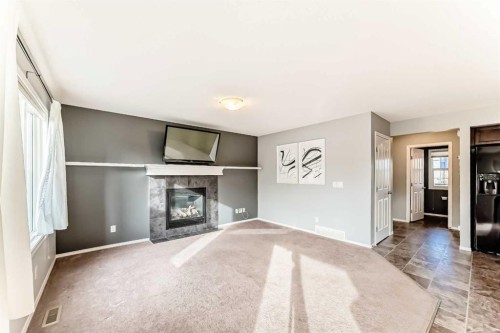 1809 Baywater Gardens Sw, Airdrie, AB - Indoor Photo Showing Living Room With Fireplace