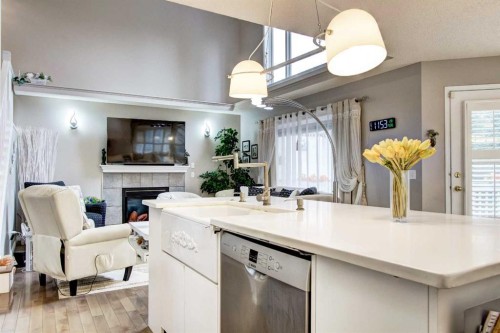 1121 Sierra Morena Court Sw, Calgary, AB - Indoor Photo Showing Kitchen With Fireplace With Double Sink