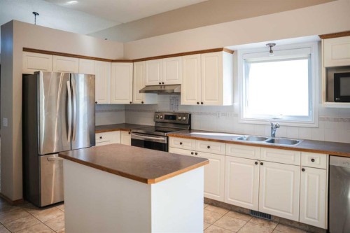 445 Rocky Ridge Bay Nw, Calgary, AB - Indoor Photo Showing Kitchen With Stainless Steel Kitchen With Double Sink