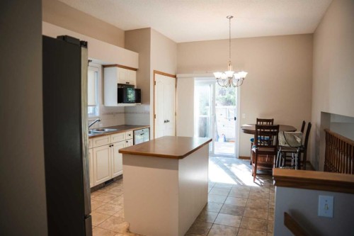 445 Rocky Ridge Bay Nw, Calgary, AB - Indoor Photo Showing Kitchen With Double Sink