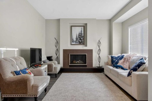 146 Marquis Common Se, Calgary, AB - Indoor Photo Showing Living Room With Fireplace