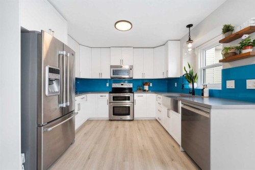 103 Sunset Place, Okotoks, AB - Indoor Photo Showing Kitchen With Stainless Steel Kitchen