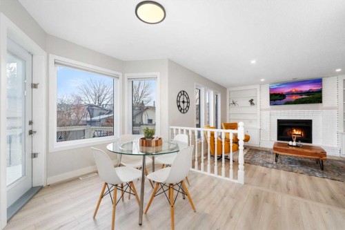 103 Sunset Place, Okotoks, AB - Indoor Photo Showing Dining Room With Fireplace