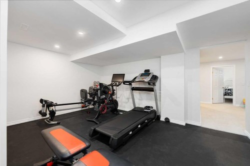 103 Sunset Place, Okotoks, AB - Indoor Photo Showing Gym Room