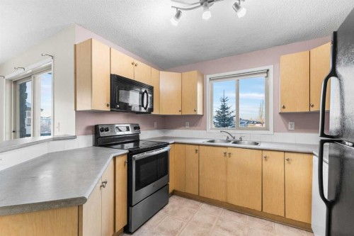 1202-16969 24 Street Sw, Calgary, AB - Indoor Photo Showing Kitchen With Double Sink