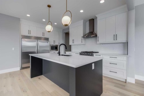 1209 Coopers Drive Sw, Airdrie, AB - Indoor Photo Showing Kitchen With Upgraded Kitchen