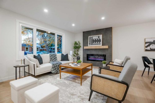 1024 Hunterston Place Nw, Calgary, AB - Indoor Photo Showing Living Room With Fireplace