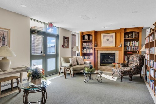 314-4500 50 Avenue, Olds, AB - Indoor Photo Showing Living Room With Fireplace