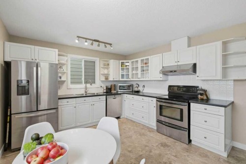 2708 Doverbrook Road Se, Calgary, AB - Indoor Photo Showing Kitchen With Stainless Steel Kitchen With Double Sink