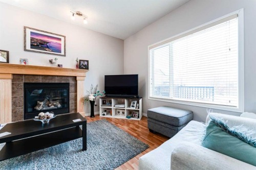 461 Boulder Creek Way Se, Langdon, AB - Indoor Photo Showing Living Room With Fireplace