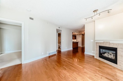 701-920 5 Avenue Sw, Calgary, AB - Indoor Photo Showing Living Room With Fireplace