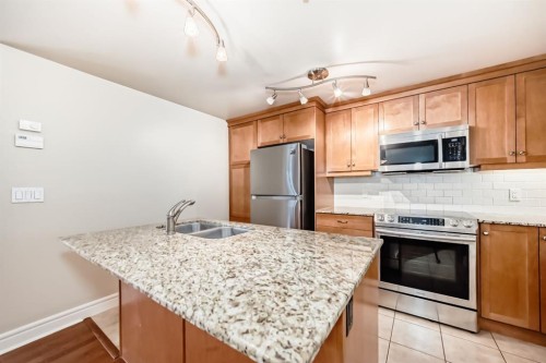 701-920 5 Avenue Sw, Calgary, AB - Indoor Photo Showing Kitchen With Stainless Steel Kitchen With Double Sink