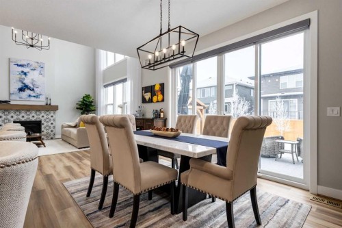 18 South Shore Bay, Chestermere, AB - Indoor Photo Showing Dining Room With Fireplace
