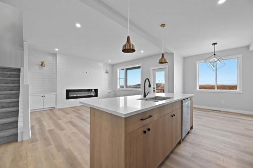 3430 Victory Way, Olds, AB - Indoor Photo Showing Kitchen With Fireplace