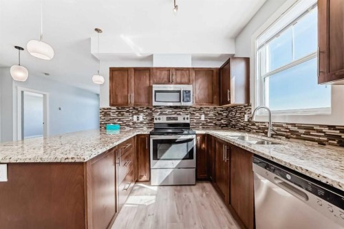 417-2300 Evanston Square Nw, Calgary, AB - Indoor Photo Showing Kitchen With Stainless Steel Kitchen With Double Sink With Upgraded Kitchen