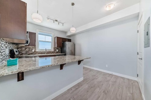 417-2300 Evanston Square Nw, Calgary, AB - Indoor Photo Showing Kitchen With Upgraded Kitchen