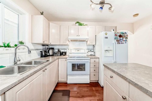 187 Taravista Street Ne, Calgary, AB - Indoor Photo Showing Kitchen With Double Sink