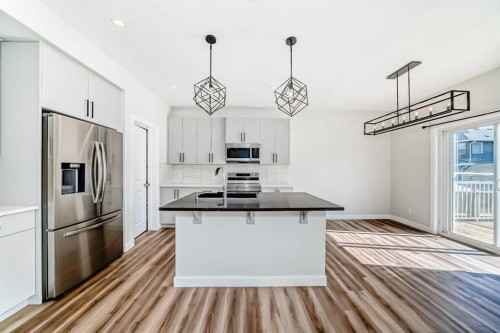 105 Creekside Way Sw, Calgary, AB - Indoor Photo Showing Kitchen With Stainless Steel Kitchen With Double Sink With Upgraded Kitchen
