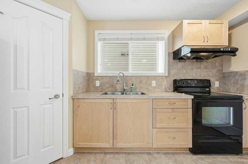 101 Panamount Manor Nw, Calgary, AB - Indoor Photo Showing Kitchen With Double Sink